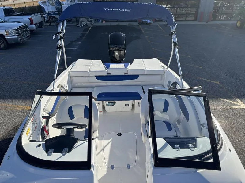 Slide: The Image of 2024 Tahoe 200 S boat with open cockpit and seating, parked outdoors. - 17