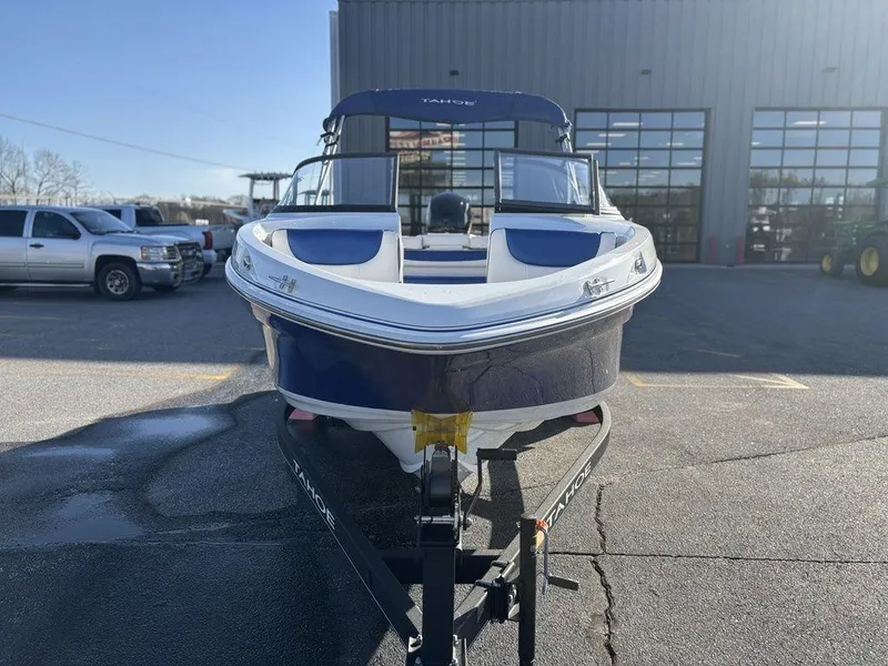 Slide: The Image of 2024 Tahoe 200 S boat on trailer, parked outdoors near a building. - 3