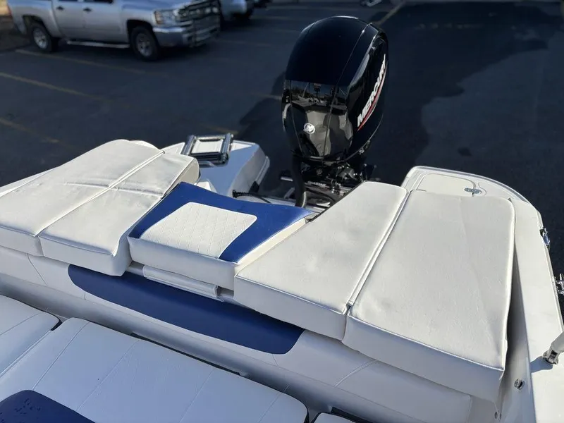 Slide: The Image of 2024 Tahoe 200 S boat with white seating and outboard motor in parking lot. - 8