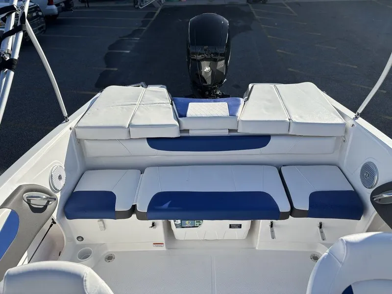 Slide: The Image of 2024 Tahoe 200 S boat interior with blue and white seating, outboard motor visible. - 9