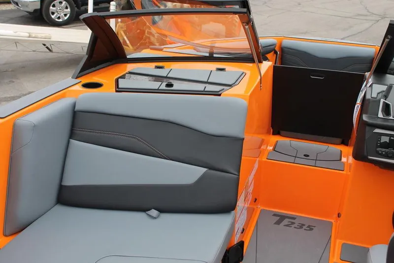 Slide: The Image of 2024 Axis T235 boat interior with orange and gray seating, modern design. - 10