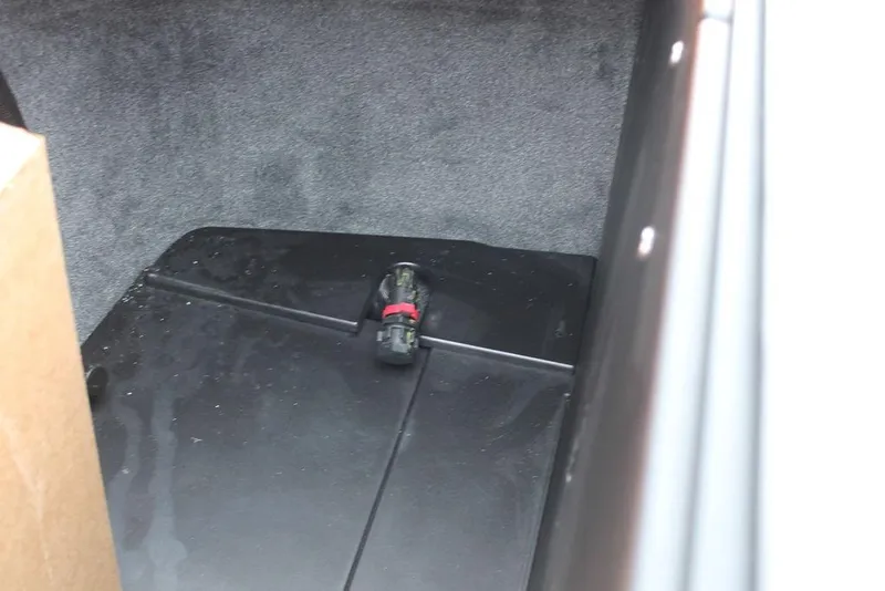 Slide: The Image of 2024 Axis T235 interior compartment with black flooring and connector. - 13