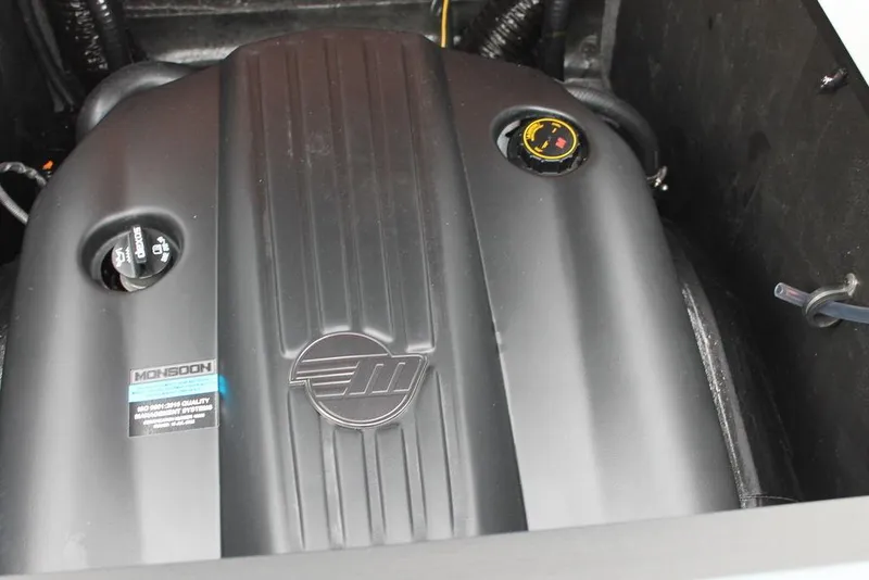 Slide: The Image of 2024 Axis T235 engine compartment with sleek black cover and visible oil cap. - 14