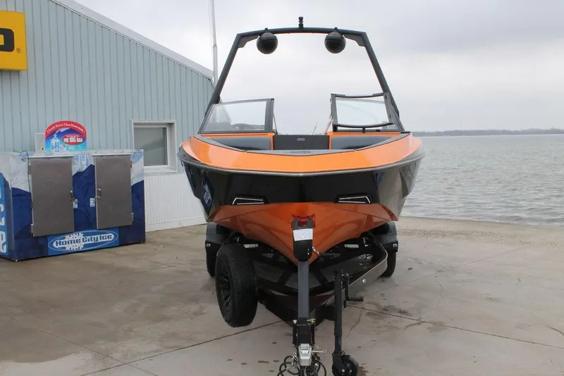 Slide: The Image of 2024 Axis T235 boat on trailer by waterfront, featuring orange and black design. - 3