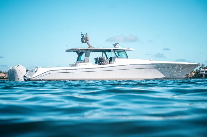 Slide: The Image of 2023 HCB 65 Estrella luxury boat on calm blue water. - 0