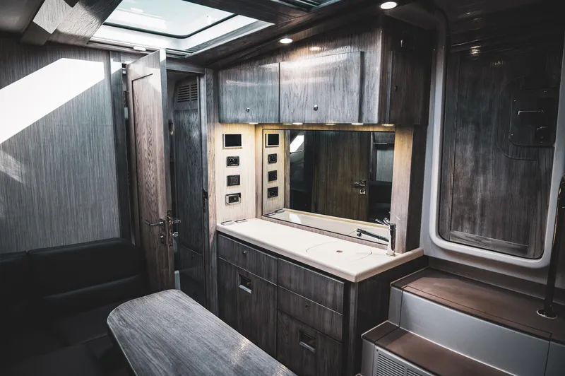 Slide: The Image of Luxurious interior of 2023 HCB 65 Estrella yacht with modern wood finishes and skylight. - 5