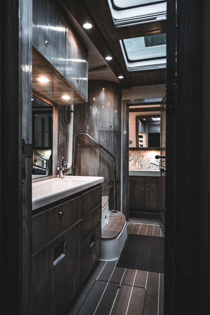 Slide: The Image of Luxurious bathroom interior of 2023 HCB 65 Estrella yacht with wooden finishes and modern fixtures. - 7