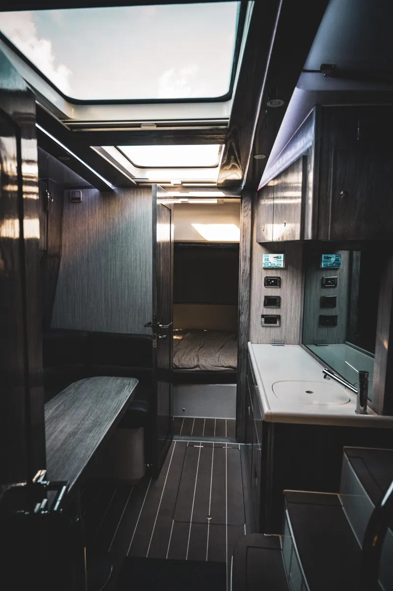 Slide: The Image of Interior of 2023 HCB 65 Estrella luxury yacht with skylights, dining area, and sleeping quarters. - 9