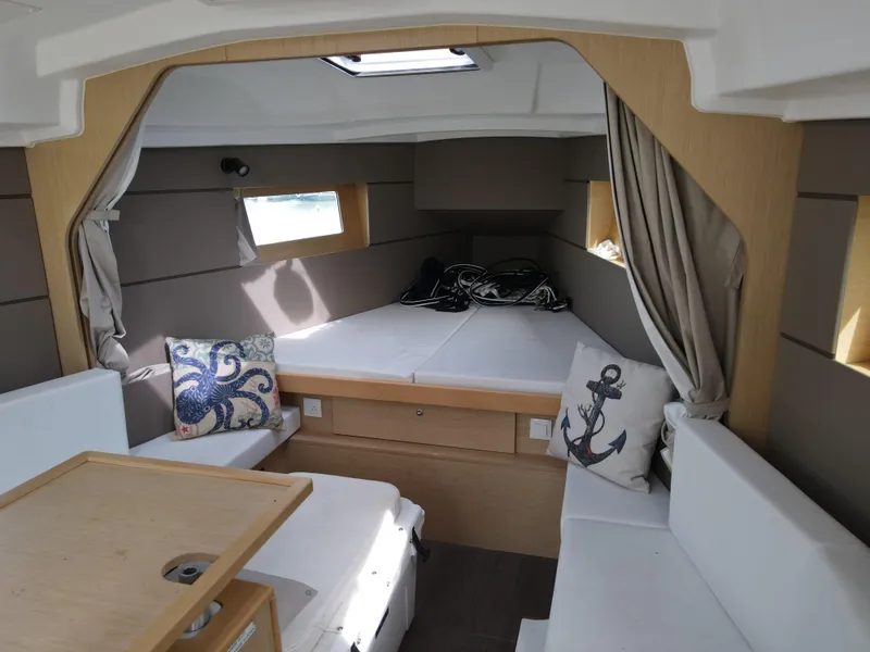 Slide: The Image of Interior cabin of 2016 Beneteau Oceanis 35.1 sailboat with cozy seating and nautical decor. - 10