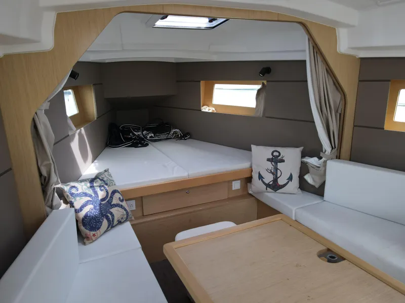 Slide: The Image of Interior of 2016 Beneteau Oceanis 35.1 sailboat with cozy seating and nautical decor. - 11