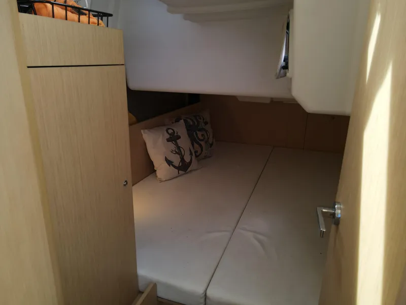 Slide: The Image of Interior cabin of 2016 Beneteau Oceanis 35.1 sailboat with anchor-themed pillows. - 12