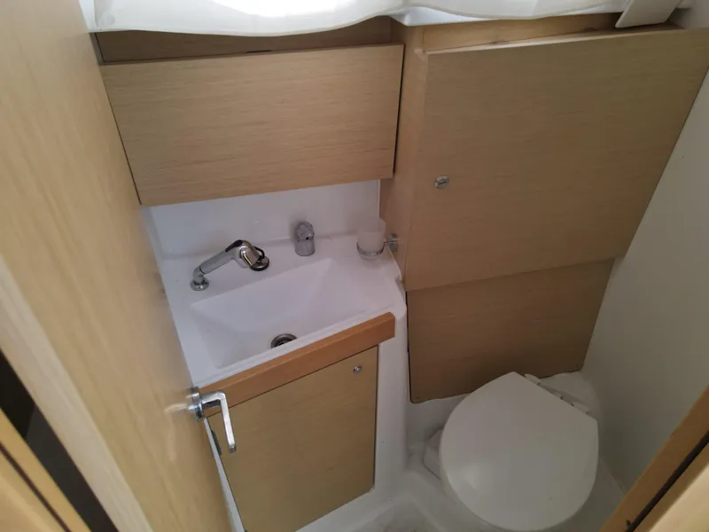 Slide: The Image of Compact bathroom in 2016 Beneteau Oceanis 35.1 sailboat with sink and toilet. - 13