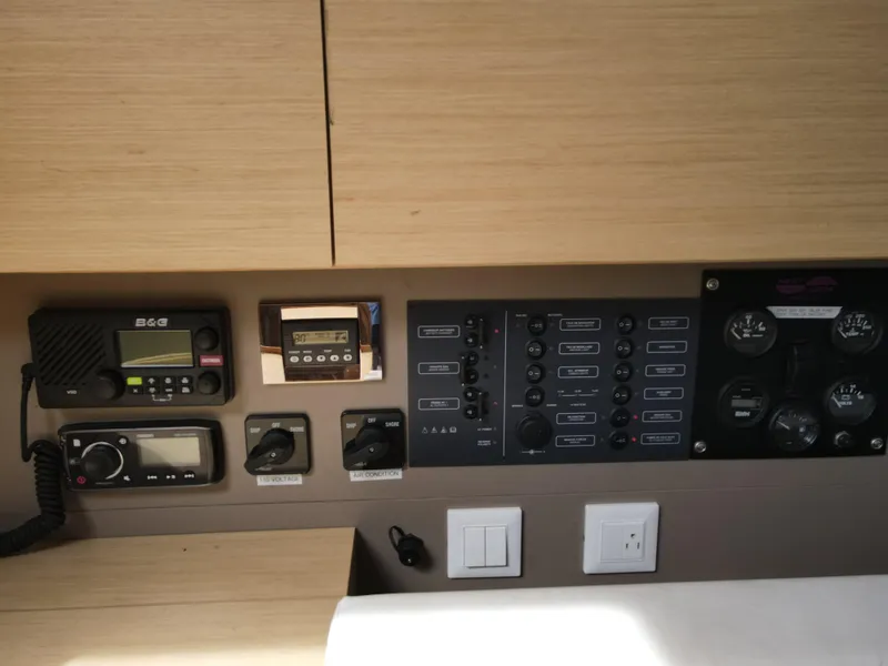 Slide: The Image of Control panel of a 2016 Beneteau Oceanis 35.1 sailboat with various instruments and switches. - 21