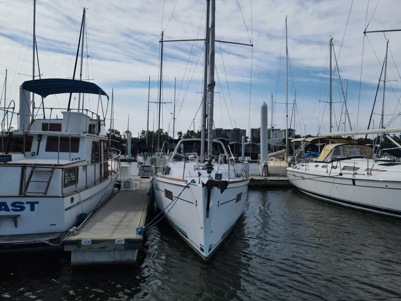 Slide: The Image of Beneteau Oceanis 35.1 2016 sailboat docked at a marina between other boats. - 3