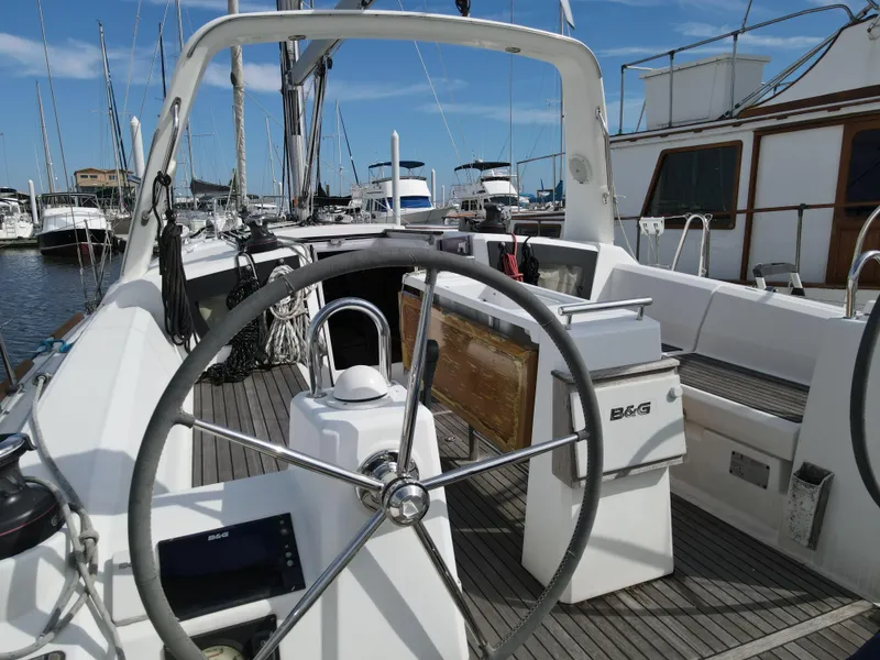 Slide: The Image of 2016 Beneteau Oceanis 35.1 sailboat cockpit with steering wheel and navigation equipment. - 6
