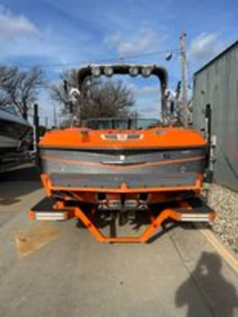 Slide: The Image of 2014 MasterCraft X30 boat, orange and gray, rear view on a trailer. - 3