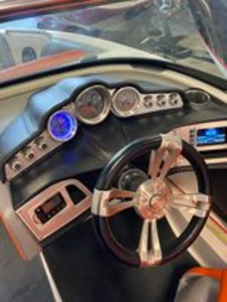 Slide: The Image of 2014 MasterCraft X30 boat dashboard with steering wheel and instrument panel. - 7