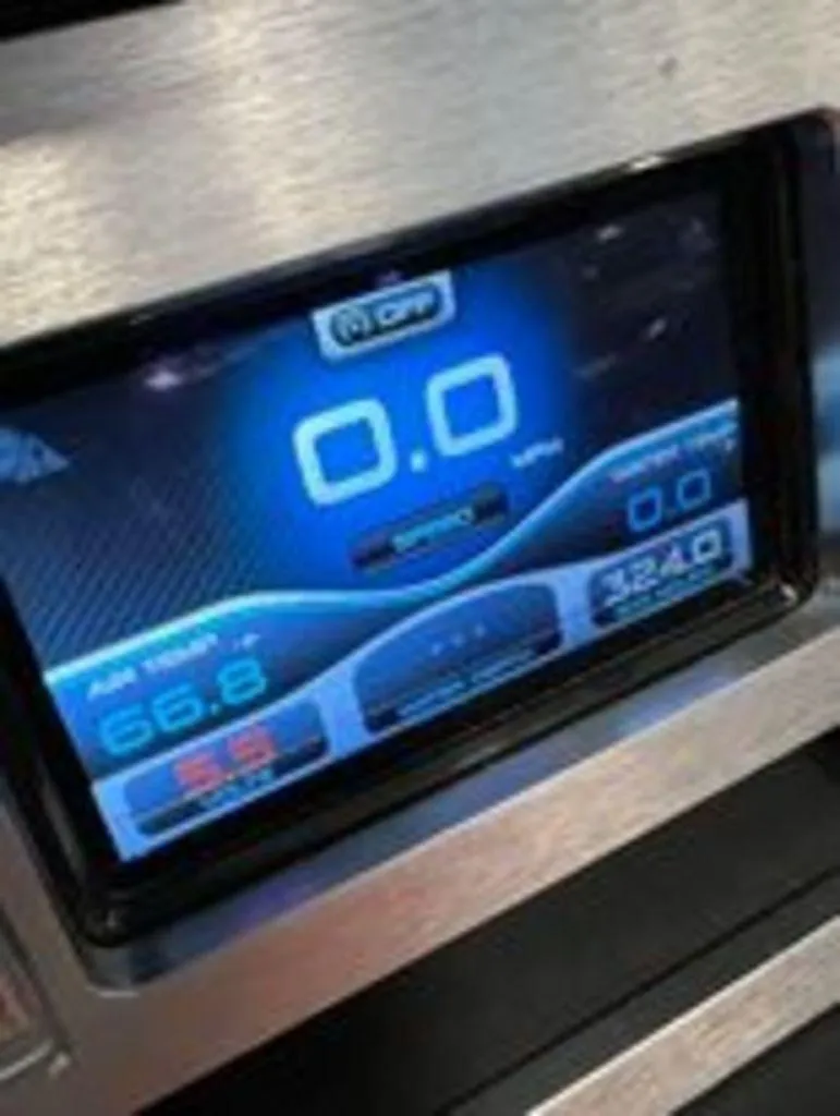 Slide: The Image of 2014 MasterCraft X30 digital dashboard display showing speed and air temperature. - 8