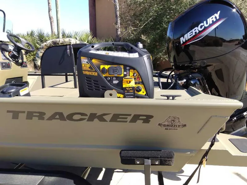 Slide: The Image of 2024 Tracker Grizzly 2072 CC Sportsman boat with Mercury outboard motor. - 2