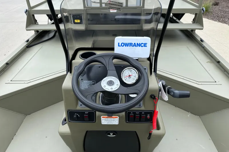 Slide: The Image of 2024 Tracker Grizzly 2072 CC Sportsman boat console with steering wheel and Lowrance display. - 8