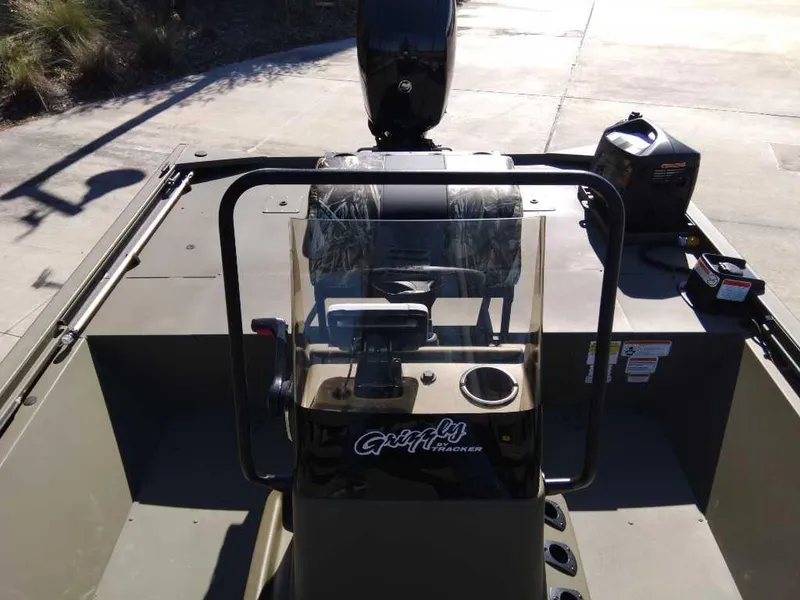 Slide: The Image of 2024 Tracker Grizzly 2072 CC Sportsman boat console and seating area. - 3