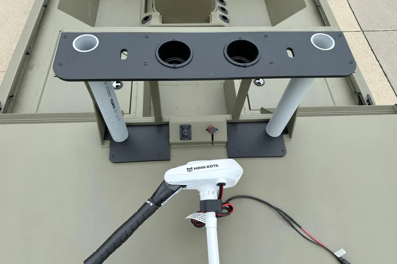 Slide: The Image of 2024 Tracker Grizzly 2072 CC Sportsman boat with Minn Kota trolling motor and rod holders. - 13