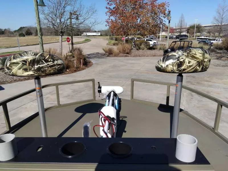 Slide: The Image of 2024 Tracker Grizzly 2072 CC Sportsman boat with camo seats and fishing rod holders. - 6