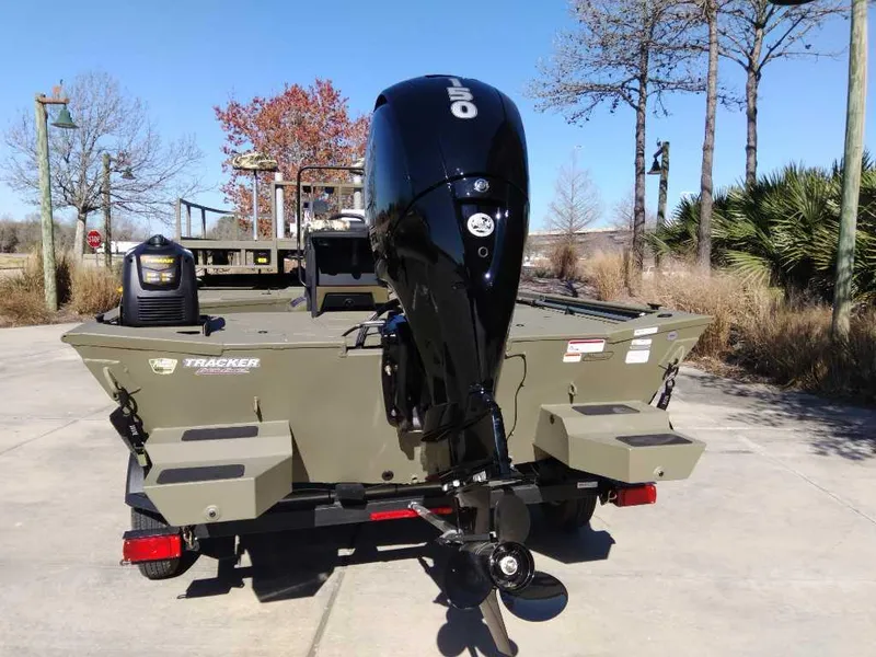 Slide: The Image of 2024 Tracker Grizzly 2072 CC Sportsman boat with outboard motor, rear view. - 7