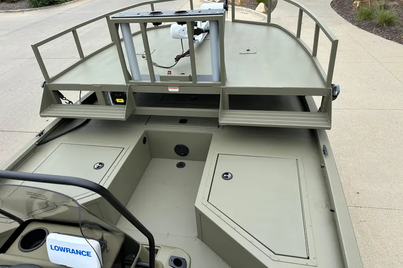 Slide: The Image of 2024 Tracker Grizzly 2072 CC Sportsman boat interior with storage compartments and Lowrance equipment. - 11