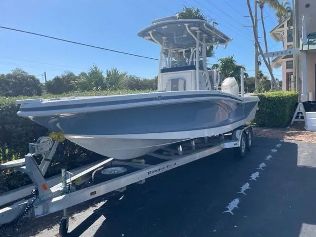 Slide: The Image of 2024 Ranger 2660 Bay boat on trailer in driveway. - 0