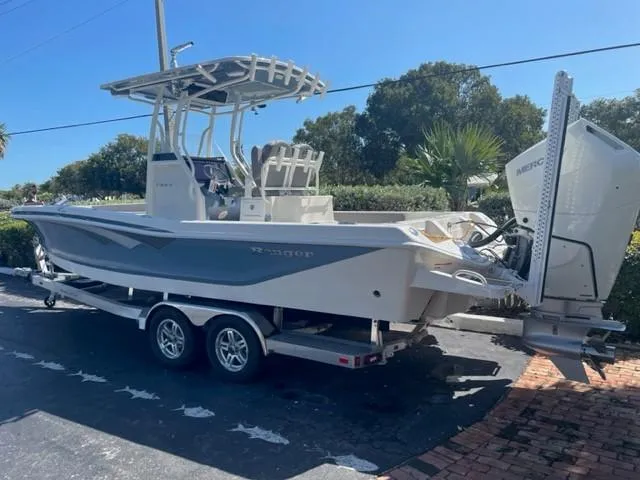 Slide: The Image of 2024 Ranger 2660 Bay boat on a trailer in a sunny outdoor setting. - 1