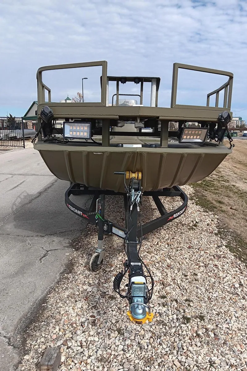 Slide: The Image of 2024 Tracker Grizzly 2072 CC Sportsman boat on a trailer, front view. - 3