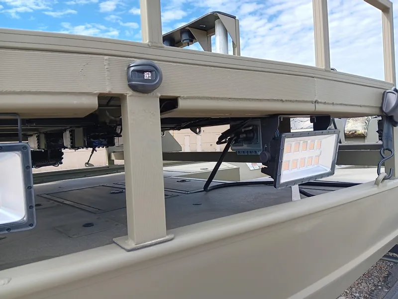 Slide: The Image of 2024 Tracker Grizzly 2072 CC Sportsman boat with LED lights and beige exterior. - 4