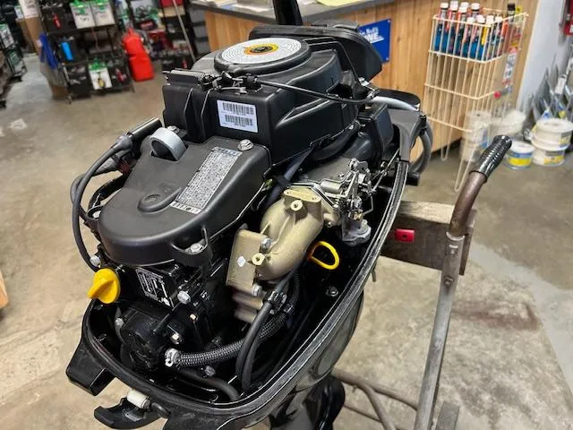 Slide: The Image of 2015 Mercury 15ML outboard motor in a workshop setting. - 4