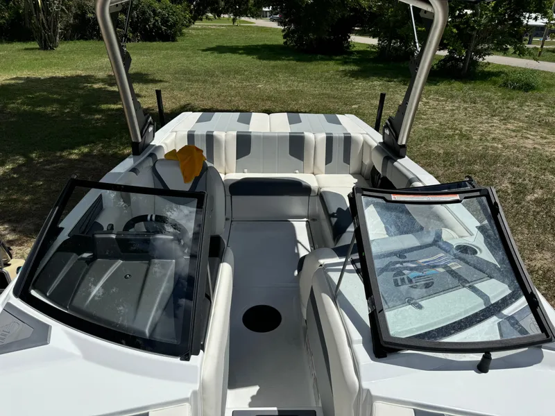Slide: The Image of 2024 Malibu LX-R boat interior with open windshield and seating area. - 10