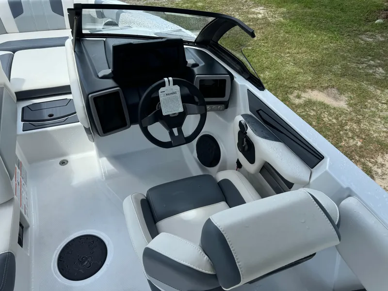 Slide: The Image of 2024 Malibu LX-R boat cockpit with modern steering wheel and dashboard. - 12