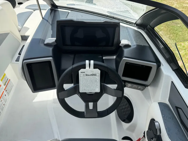 Slide: The Image of 2024 Malibu LX-R boat dashboard with steering wheel and digital displays. - 13