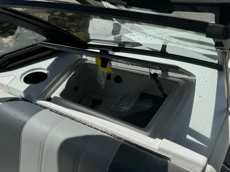 Slide: The Image of 2024 Malibu LX-R boat storage compartment with open lid. - 16
