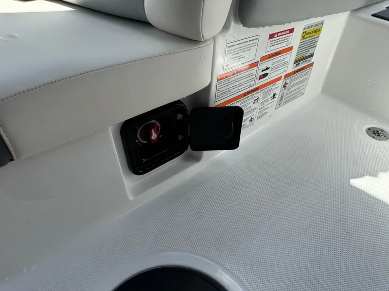 Slide: The Image of 2024 Malibu LX-R boat interior with safety instructions and storage compartment. - 18