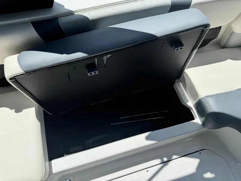 Slide: The Image of 2024 Malibu LX-R boat storage compartment with open seat cushion. - 19