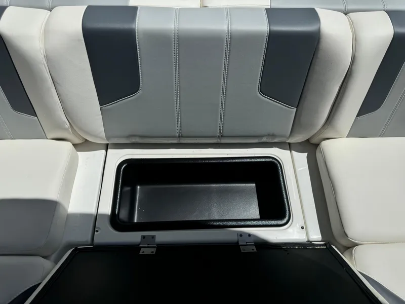 Slide: The Image of 2024 Malibu LX-R boat seat with open storage compartment. - 20