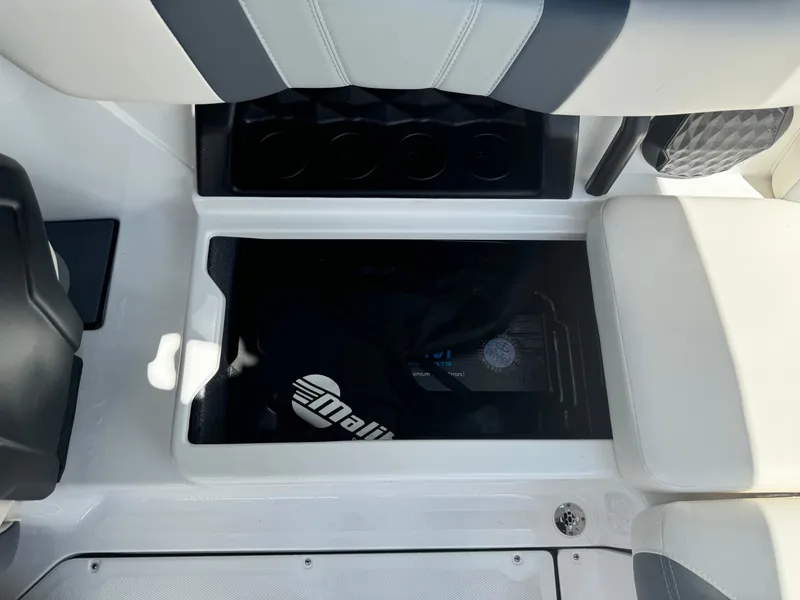 Slide: The Image of 2024 Malibu LX-R boat interior storage compartment with cup holders. - 21