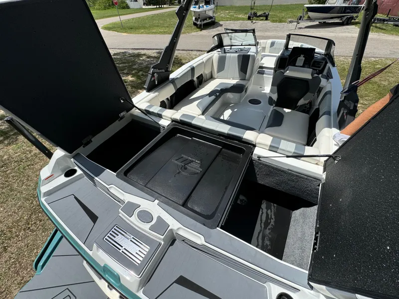 Slide: The Image of 2024 Malibu LX-R boat interior with open storage compartments and seating. - 26
