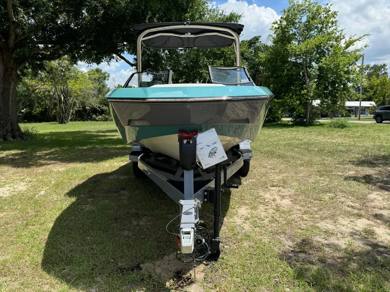 Slide: The Image of 2024 Malibu LX-R boat on a trailer in a grassy area. - 3