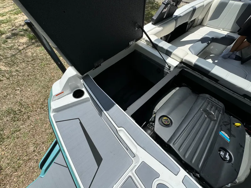 Slide: The Image of 2024 Malibu LX-R boat engine compartment and seating area. - 30