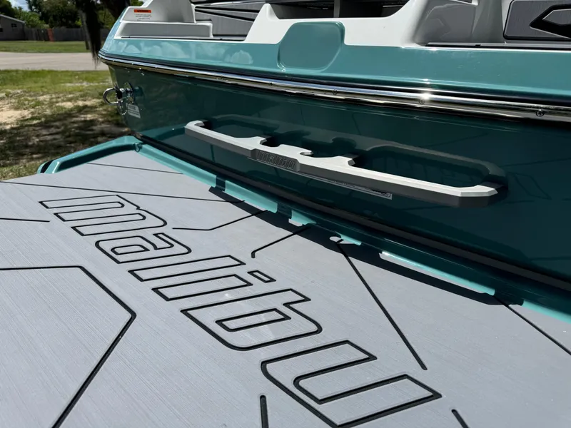 Slide: The Image of 2024 Malibu LX-R boat rear deck with logo in sunlight. - 32
