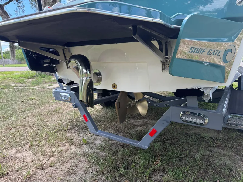 Slide: The Image of 2024 Malibu LX-R boat with Surf Gate system and propeller, rear view. - 39