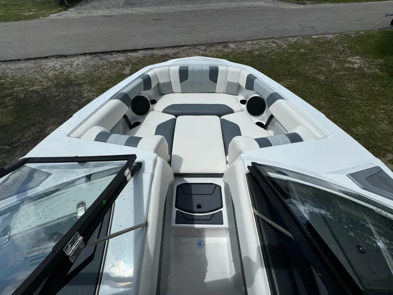 Slide: The Image of 2024 Malibu LX-R boat interior with cushioned seating and storage compartments. - 6