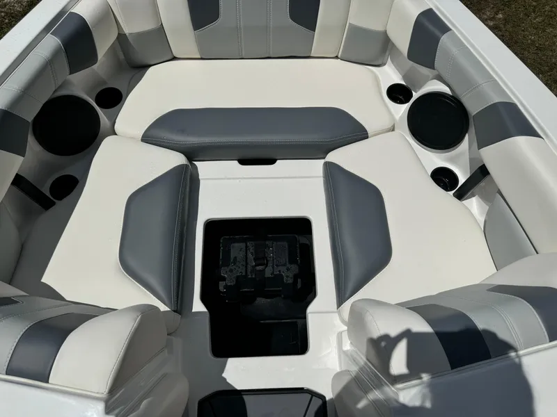 Slide: The Image of 2024 Malibu LX-R boat interior with white and gray cushioned seating. - 7