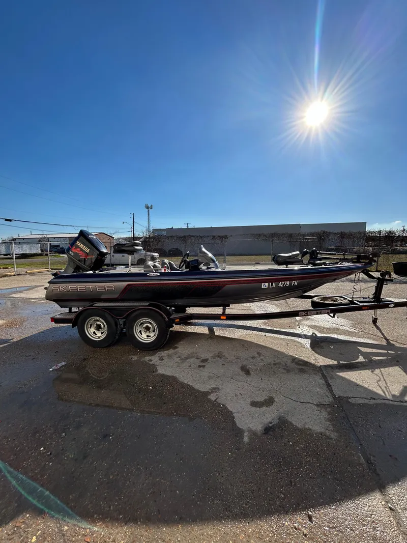 Slide: The Image of 2003 Skeeter SX 200 fishing boat with red and gray seats. - 10